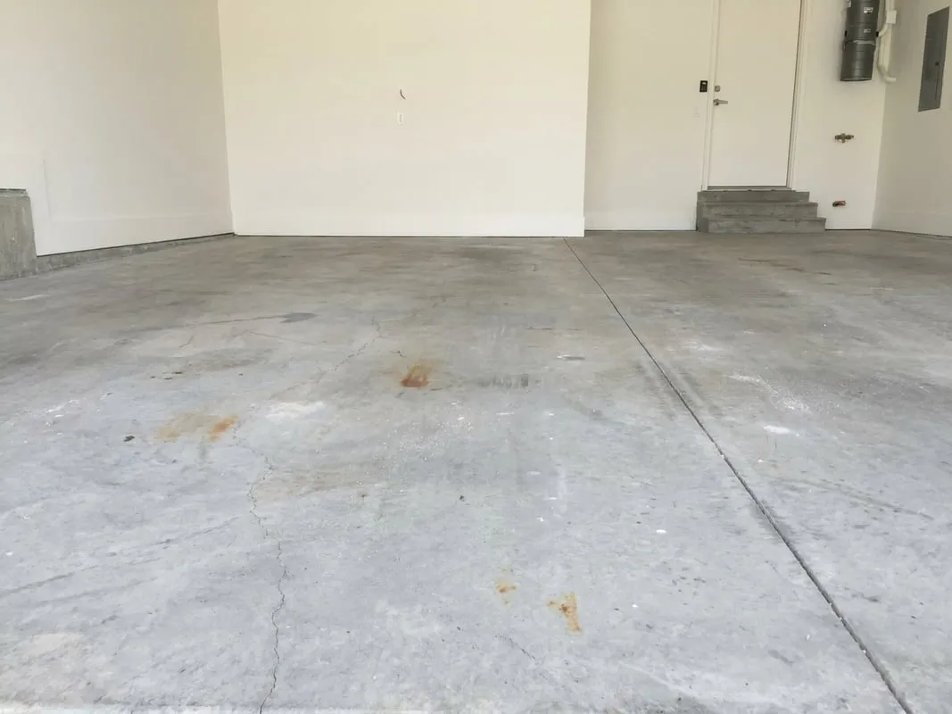 Bare, uncoated concrete garage slab before prep and coating