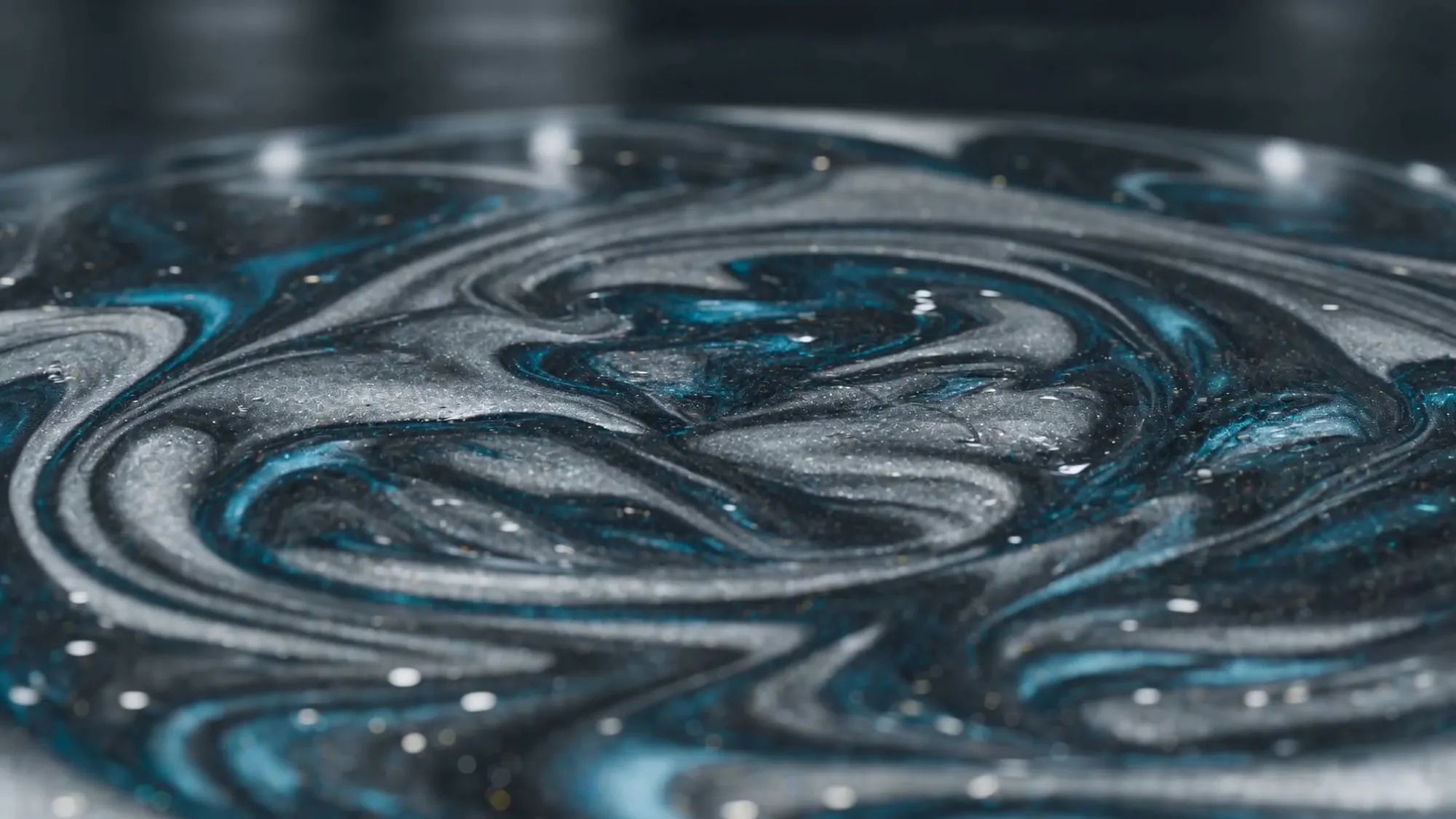 A finished metallic epoxy floor by LB Epoxy Flooring — swirled silver and steel-blue with a deep mirror-gloss sheen